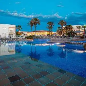 Sirenis Hotel Club Aura at dusk in a resort.