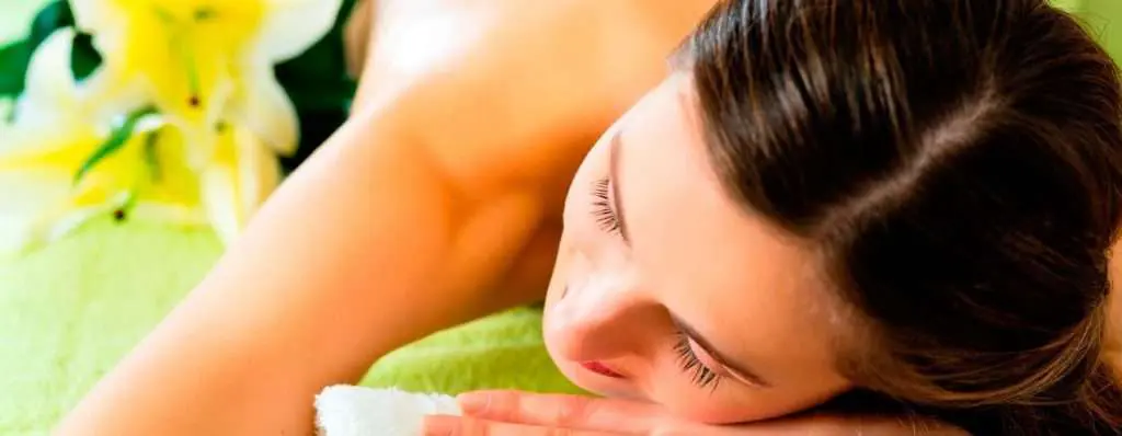 a woman is getting a massage at a spa.